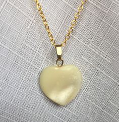 "Off white pearly heart pendant necklace, on a gold plated chain. The length of the necklace is 20\" and the pendant is about .875\" long. Also, please take a look at my storefront at: https://www.etsy.com/shop/FabFinds42?ref=seller-platform-mcnav I have a wide selection of one-of-a-kind items, from clothing and toys to home decor and gift items, and I add new things almost every day." White Heart Necklace With Pearl Pendant, White Heart Pendant Charm Necklace With Pearl, White Pearl Heart Pendant Charm Necklace, White Heart Pendant Charm Necklace With Heart Beads, White Heart Charm Round Pendant Necklace, Heart-shaped Pearl Pendant Charm Necklace, White Heart Charm Necklace With Round Pendant, White Heart Beads Charm Necklace With Heart Pendant, White Heart Necklace With Pearl Pendant As Gift