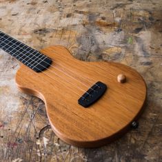 a small wooden guitar sitting on top of a table