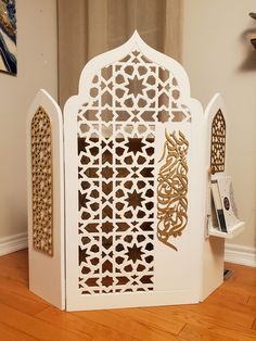 an intricately designed white and gold display case