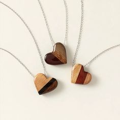 Strength of Love Wood Necklace | Jewelry | Uncommon Goods Wood Heart Necklace, Wooden Pendant Necklace, Uncommon Goods, Handmade Heart, Wood Hearts, Wood Necklace, Resin Coating, Wooden Pendant, Sterling Silver Chain