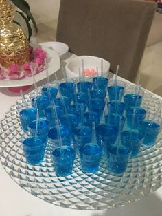 there are many glasses on the table with toothpicks in them and one is blue