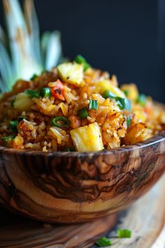 a wooden bowl filled with rice and vegetables