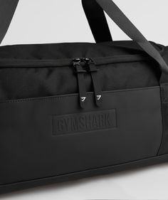 Gymshark Small Everyday Gym Bag - Black Large Capacity Gym Bag, Sporty Black Travel Bag With Functional Pockets, Versatile Black Duffle Bag With Functional Pockets, Black Waterproof Duffle Bag For Everyday Use, Durable Functional Bags For Daily Use, Functional Durable Bags For Daily Use, Durable Everyday Use Travel Bag, Durable Functional Travel Bag For Everyday Use, Nylon Rectangular Gym Bag For Everyday Use