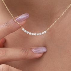 Elevate your style with our dainty 14k Curved Bar Diamond Necklace. This minimalist and handcrafted piece features a delicate bar pendant adorned with sparkling diamonds, making it the perfect wedding gift for her. Embrace the elegance and timeless beauty of this handmade diamond jewelry. Order now and make a statement of sophistication! Alternatively, choose from our options of natural, lab-grown diamonds or dazzling moissanites at three different price points to fit your unique preferences and budget. Please check below to see specifications of each stone option. All our pieces come with Azalea Certification and Warranty document.  Independent appraisals cost an additional $60. All pieces over $2,000 come with free appraisal. M A T E R I A L & L E N G T H Available in 14k Yellow Gold, 14 Diamond Necklace Pendant Ideas, Minimalist 14k Gold Bar Necklace For Anniversary, 14k Gold Bar Necklace For Anniversary, Gold Diamond Bar Necklace For Anniversary, Anniversary Gold Diamond Bar Necklace, Classic Yellow Gold Bar Necklace For Anniversary, Minimalist Diamond Necklace, Diamond Birthday, Dainty Bar Necklace