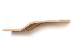 a wooden shelf that has some kind of curved object on it's side, against a white background