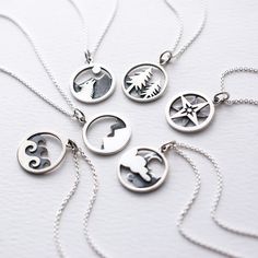 Recycled Sterling Silver Adventure Necklaces are the best way to remind ourselves where our happy place is. Beautifully handcrafted pendants can be worn alone or layered with other necklaces. Choose from: Dog Howling, Trees, Star Compass, Sky, Mountains, Waves. This pendant comes on a 18" Sterling silver chain. 18" Sterling Silver Cable Chain from US, Lead and Nickel Free. Recycled Sterling Silver Adventure Pendants made in Thailand Shipped from our studio in Oregon Bohemian Personalized Necklaces For Everyday, Everyday Personalized Bohemian Necklaces, Everyday Bohemian Personalized Necklaces, Nature-inspired Sterling Silver Pendant Charm Necklace, Souvenir Round Pendant Necklace With Charms, Everyday Symbolic Handmade Charm Necklaces, Sterling Silver Everyday Necklace With Nature-inspired Style, Everyday Sterling Silver Nature-inspired Necklace, Everyday Nature-inspired Sterling Silver Necklace