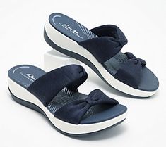 Is a trip to the shore in your future? Slip into these supremely comfortable slides and you're ready for a day of boardwalk strolls and sightseeing. From Clarks Footwear. Comfortable Slides With Ortholite Insole For The Beach, Ortholite Slide Sport Sandals For Vacation, Adjustable Slippers With Ortholite Insole For Summer, Beach Slide Slippers With Ortholite Insole, Comfortable Slides With Arch Support For Vacation, Comfortable Synthetic Sandals For Outings, Comfortable Summer Flip Flops With Ortholite Insole, Beach Season Sandals With Arch Support, Vacation Slippers With Arch Support