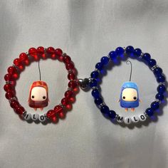 two beaded bracelets with cartoon characters on them, one is red and the other is blue