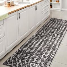 a black and white rug in a kitchen