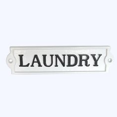 a white sign that reads laundry on it's front and back ends with black lettering