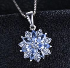 Enhance your jewelry collection with this JewelryPalace Flower Pendant Necklace, featuring a stunning 1.2ct created blue spinel. Crafted from 925 sterling silver, this pendant showcases an intricate floral design that adds a touch of nature-inspired beauty to your look. Whether worn alone or layered, this piece is perfect for adding sophistication to any outfit. Blue Flower-shaped Diamond Jewelry, Elegant Sapphire Flower-shaped Jewelry, Elegant Sapphire Flower Jewelry, Formal Sapphire Flower Jewelry, Sapphire Flower-shaped Jewelry Gift, Sapphire Flower-shaped Jewelry For Gifts, Sapphire Flower Shaped Jewelry For Gifts, Flower Shaped Sapphire Jewelry Gift, Blue Spinel