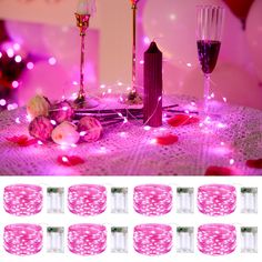 the table is set up with candles and rose petals on it, surrounded by pink lights