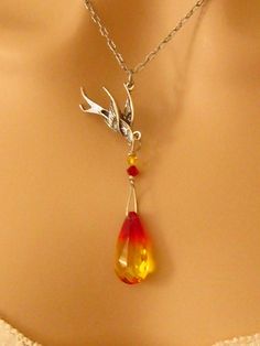 "Swarovski Phoenix Jewelry Gift for Her, Encouragement Necklace, Strength Necklace: Rebirth of an intricately detailed phoenix as it rises above the flames of a genuine Swarovski fire opal crystal in this beautiful Phoenix Necklace. This highly refractive crystal graduates from yellow to a fiery orangish red and is wire wrapped with two smaller Swarovski crystals onto the phoenix. The entire phoenix pendant hangs from a delicate antiqued silver plated chain. Phoenix Earrings: These long Swarovsk Encouragement Jewelry, Fire Necklace, Phoenix Jewelry, Phoenix Necklace, Phoenix Pendant, Fire Bird, Symbol Necklace, Bird Necklace, Bird Jewelry