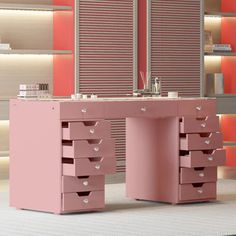 a pink desk with drawers in front of shelves