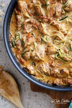 a pan filled with pasta and meat covered in sauce