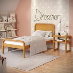 a child's bedroom with pink walls and white stars on the wall above the bed