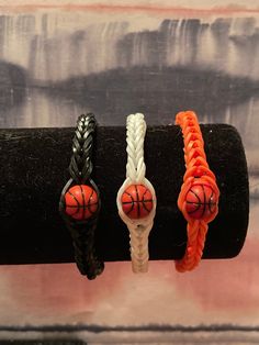 three braid bracelets with basketball balls on them