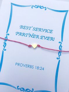 a red string bracelet with a gold heart on it and the words best service partner ever