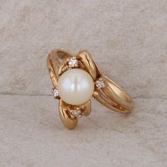 This ladies 14k yellow gold ring has a 7-7.5mm freshwater cultured pearl in the center. There are four round diamonds around the pearl that equal 0.10ctw. The ring weighs 4.4 grams and the finger size is 7.5. *All items are thoroughly inspected for quality assurance purposes Pearl And Diamond Ring, Gold Necklace Designs, Ring Pictures, Gold Pearl, Multi Stone Ring, Necklace Designs, Yellow Gold Rings, Round Diamonds, Jewelry Inspiration