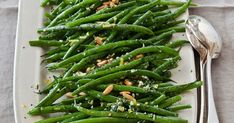 a white plate topped with green beans and nuts