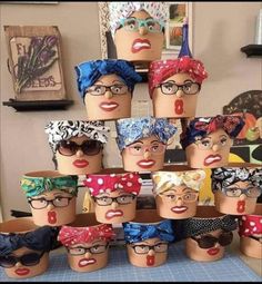 many different types of head coverings on mannequin's heads, all wearing glasses