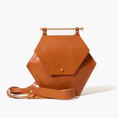 Crossbody / Shoulder Bag / Wristlet / Clutch All in one! Comes with everything you need to seamlessly convert between styles. 100% vegetable tanned leather One interior pocket. Handmade in our New York studio Size: 7" H x 8" W Includes: Long strap: Length: 46" - 48" | Drop: 22" - 23.5" Short strap: Length: 14.5" | Drop: 6.5" Leather Purses And Bags, Hexagon Bag, Cognac Leather Bag, New York Studio, Tan Cowhide, Bags Handmade, Luxury Purses, Wristlet Clutch, Leather Bags