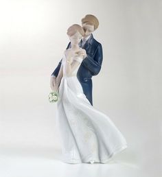 a bride and groom figurine holding each other