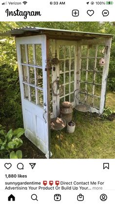 an old outhouse is sitting in the grass with buckets and other things around it