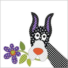 a black and white dog holding a flower with polka dots on it's face