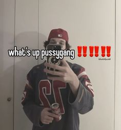 a man taking a selfie in front of a mirror with the caption what's up pussyyang?