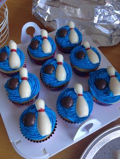 cupcakes decorated with blue icing and white frosting bowling pins