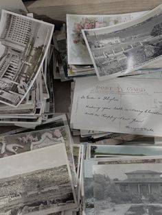 many old photographs are piled on top of each other in this pile, with the letters and numbers missing