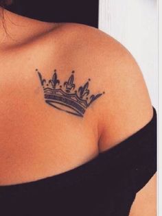 a woman with a crown tattoo on her shoulder