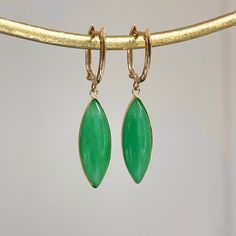 Estate 14KT Yellow Gold Oval Hoop Earrings with Bezel-Set, Marquise-Shape, Green Jade Charm Dangles Great movement and interest to these charm hoops! Length: 36mm Width: 8mm at widest jade point Weight: 3.70 grams Stamped 14k on gold Snap closure Genuine green jade Like new condition  Please check out our other jewelry items! Thank you,  Legacy Saint Jewelry -OUR RETURN POLICY-  To return an item you must first contact us within 7 days of receiving your item(s). Upon messaging us we will provide the steps in returning or exchanging. The buyer is fully responsible for paying for return shipping. We offer refunds minus $10 or 10% of the item cost (plus any mandatory taxes), whichever is greater will be subtracted from the refunded amount. Your refund will post back to you within 7 business d Modern Oval Green Jewelry, Elegant Jade Hoop Earrings, Modern Oval Jade Jewelry, Green Marquise Earrings In Fine Jewelry Style, Green Marquise Fine Jewelry Earrings, Fine Jewelry Green Marquise Earrings, Green Marquise Earrings Fine Jewelry, Oval Green Clip-on Earrings, Green Oval Clip-on Earrings