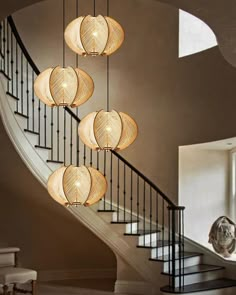 a spiral staircase with five lights hanging from it