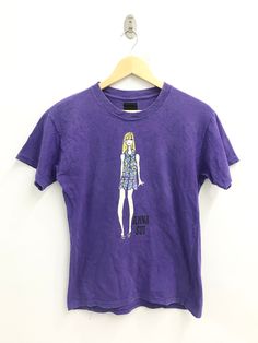 "PLEASE READ DESCRIPTION CAREFULLY BEFORE BUYING..IF YOU HAVE ANY QUESTION FEEL FREE TO ASK Vintage 90s Anna Sui tshirt Size: M Please check the actual measurements below- (All measurements were taken lying flat) ACTUAL SIZE MEASUREMENT(approximately) : ARM PIT TO ARM PIT :- 18.5\" inches LENGTH ( BACK COLLAR TO BOTTOM ):-25\" inches CONDITION :-VINTAGE CONDITION!! NO HOLES, NO STAINS (Refer photos) An item that has been used  GREAT VINTAGE CONDITION ( USED CLOTHING )  Please see pictures carefu Vintage Purple T-shirt For Summer, American Fashion Designers, American Fashion, Anna Sui, Trendy Tee, Elegant Shirt, Used Clothing, Classic Shirt, American Style