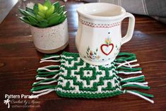 two mugs and a potted plant on a table