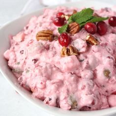 a bowl filled with fruit and nuts on top of a table