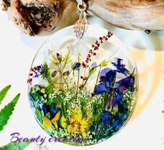 a glass ornament with wildflowers and other flowers