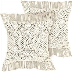 two white pillows with fringes on them