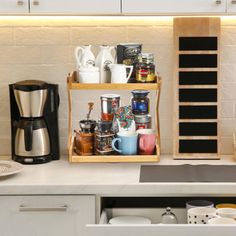 a kitchen counter with coffee maker, cups and saucers on it's shelf