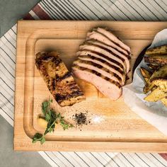 grilled meat and potatoes on a cutting board