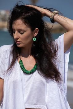 "Paper bead necklace - this eco-friendly sustainable long green statement necklace is a meaningful and beautiful handmade piece of recycled paper jewelry art. It will make an exceptional gift for any woman who loves mother earth and is eager to protect it!  This bold green paper bead necklace is made of hundreds of circular Canson paper disc beads threaded on a suede cord. It is a mesmerizing necklace that makes an enormous impression, and the fact that it is hand-made of recycled paper beads gi Unique Green Fair Trade Jewelry, Green Fair Trade Necklace For Gift, Unique Green Fair Trade Necklace, Green Handmade Eco-friendly Jewelry, Hoop Beaded Earrings, Recycled Necklace, Green Statement Earrings, Paper Bead Necklace, Earrings Paper