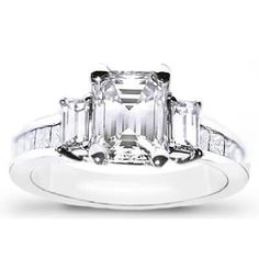 an emerald cut diamond ring with channeled shoulders