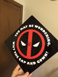 someone is holding up a deadpool cap that says, you may be wondering what the car and gowns are