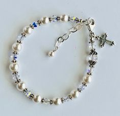 "Rosary bracelet-Granddaughter gift-Goddaughter bracelet-Goddaughter Gift-Goddaughter Present-Baby pearl bracelet-Cross bracelet-Pearl Rosary-Pearl Rosary Bracelet-Chaplet Bracelet-Flower girl bracelet-Christening bracelet-Communion bracelet This beautiful Rosary Bracelet features with Swarovski Crystal White Pearl round beads, Swarovski Crystal Bicone AB, Bali silver Daisy rondelle, and sterling silver clasp. This bracelet is approximately 6 1/2\" in length. All Parts are sterling silver. The b Adjustable Silver Pearl Bracelet For Baptism, Adjustable Hypoallergenic Rosary Bracelet For Wedding, Pearl Charm Bracelet For First Communion, Adjustable Pearl Bracelet For First Communion, Elegant Round Beads Bracelets For First Communion, Elegant Round Beads Bracelet For First Communion, Adjustable Pearl Bracelets For Baptism, Elegant Adjustable Beaded Bracelets For Baptism, Adjustable Pearl Bracelet With Charm For First Communion