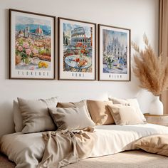 three paintings hang on the wall above a bed in a room with beige linens