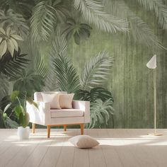 a living room with a couch, chair and wallpaper that has palm leaves on it