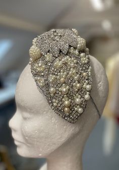 This one of kind hand stitched pearl and crystal headpiece is a fascinator and would make an ideal wedding headpiece. This could be worn either by a bride or even mother of the bride. It sparkles beautifully under light and is incredibly eye catching. It has an adjustable elastic to allow the wearer comfort and can be secured in place easily. Every bead and pearl are vintage on this headpiece with the centre piece being from the 1980s Paris. It has a pattern inspired by Egyptian princess Scotia Luxury Bead Caps Headpieces For Party, Luxury Wedding Headpieces, Elegant Crystal Headpiece For Party, Elegant Silver Beaded Headpiece, Elegant White Rhinestone Headpieces, Elegant Embellished Bridal Accessories For Ceremony, Glamorous Rhinestone Headpiece For Wedding, Glamorous Rhinestone Wedding Headpiece, Elegant Crystal Headpieces For Weddings