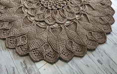 a crocheted doily is laying on the floor